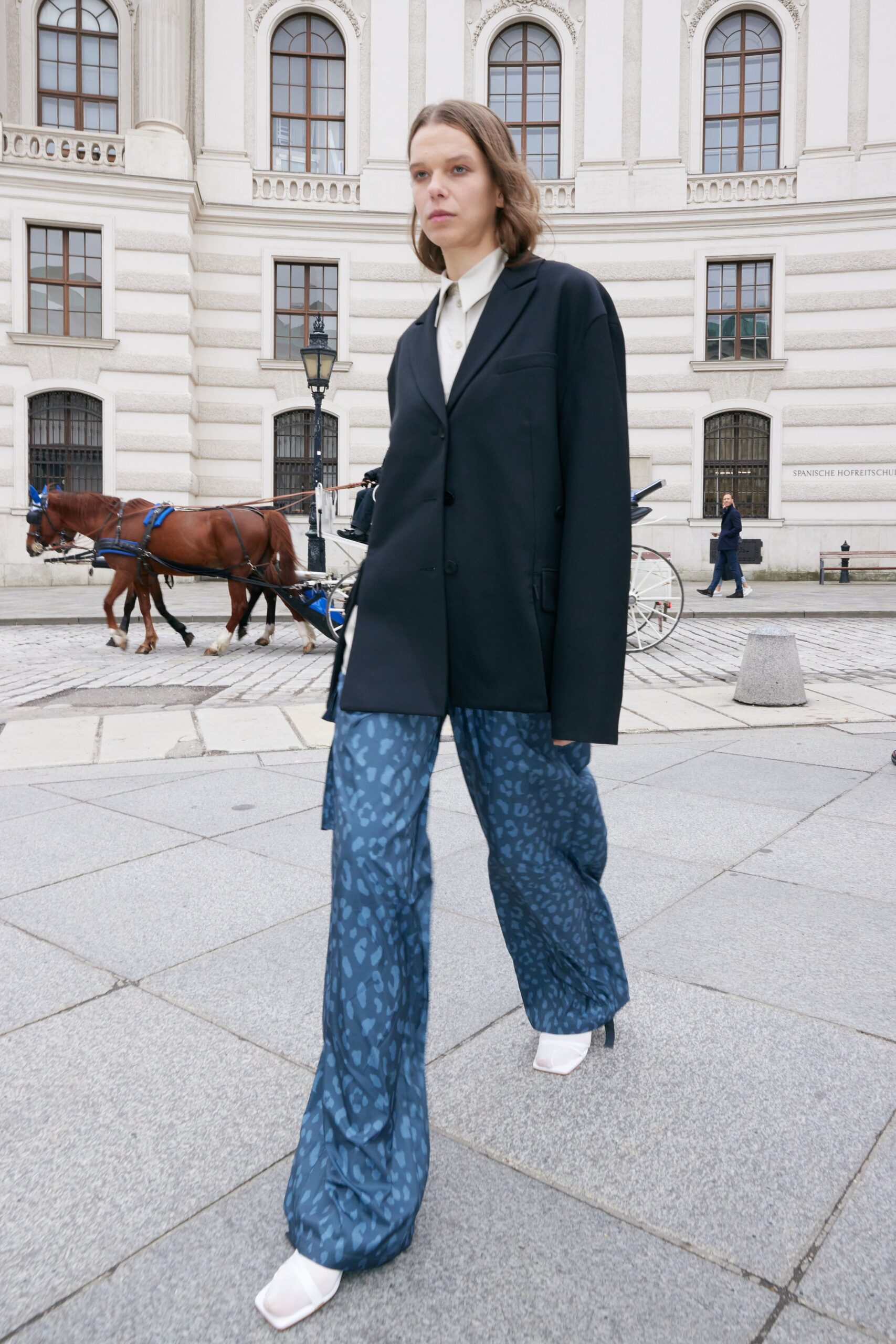 oversized black blazer with flared blue pants