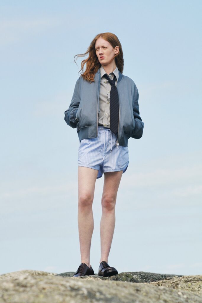 blue jacket gray shirt striped shorts
