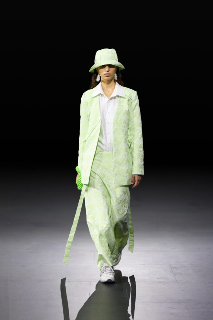 An oversized green cotton jacket paired with matching pants, creating a bold and stylish look.