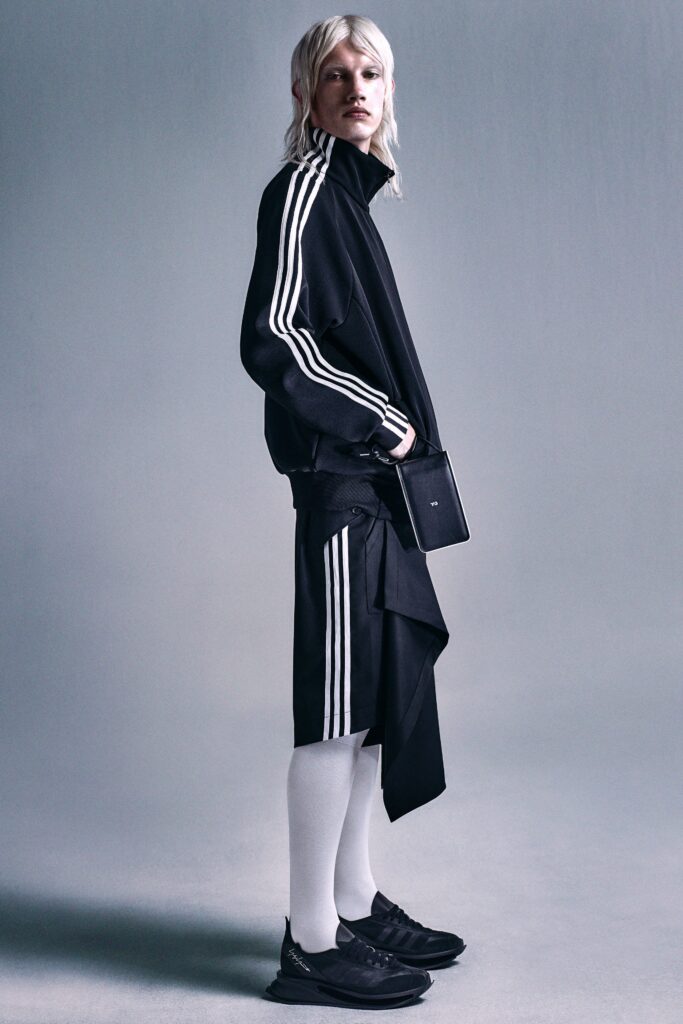 A relaxed black jacket with long sleeves and an asymmetric skirt for a modern look.