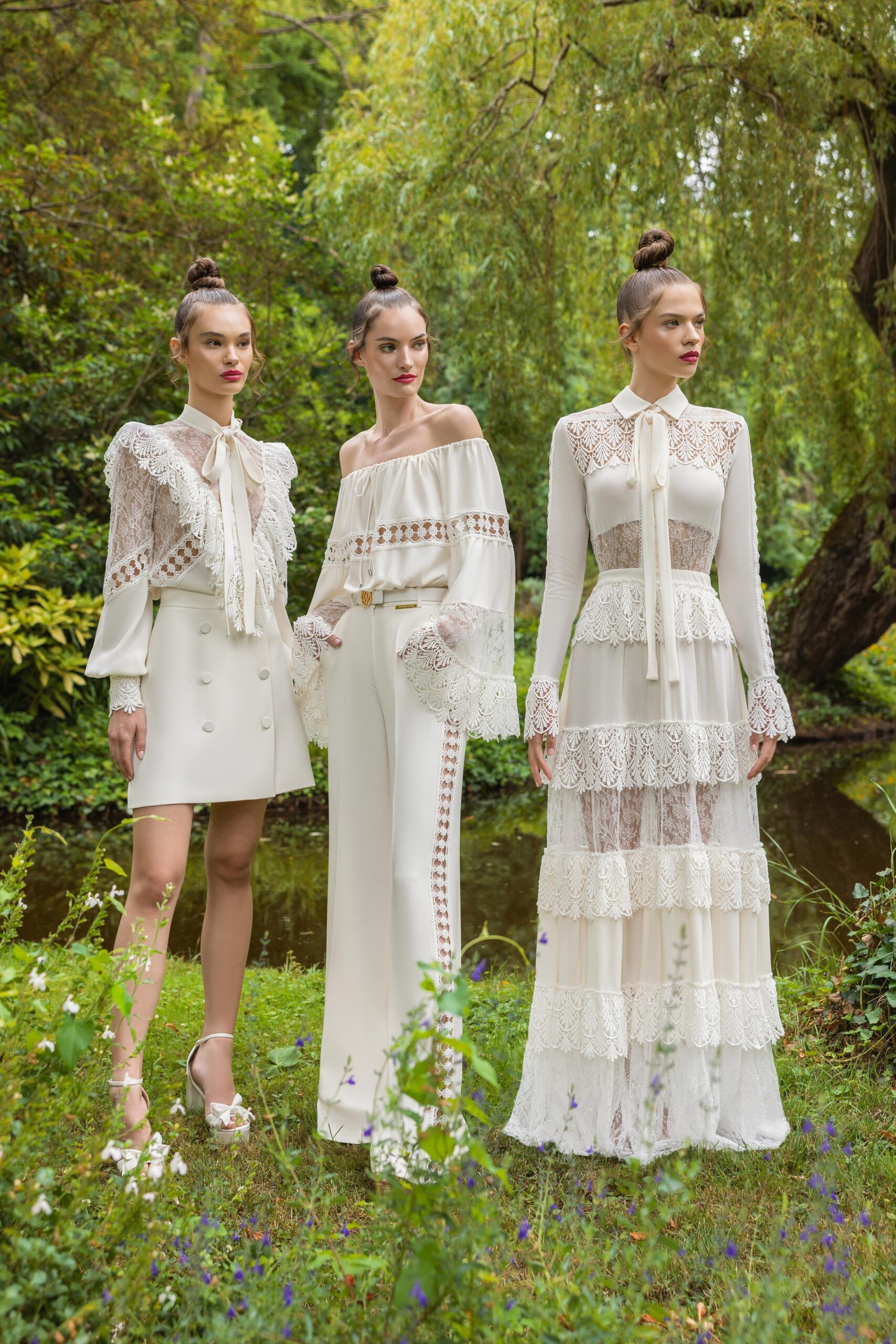 A fitted white lace dress with long sleeves and tiered design details.