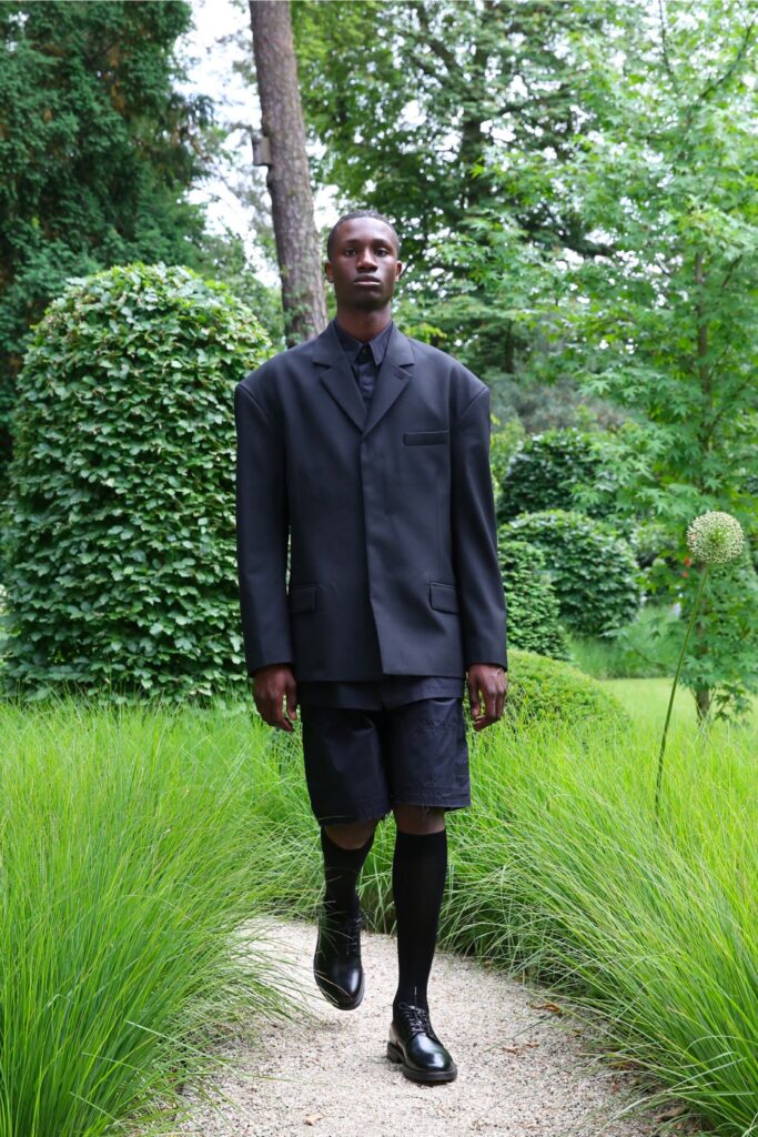 An oversized black jacket paired with matching shorts, featuring a collared design and buttoned details.