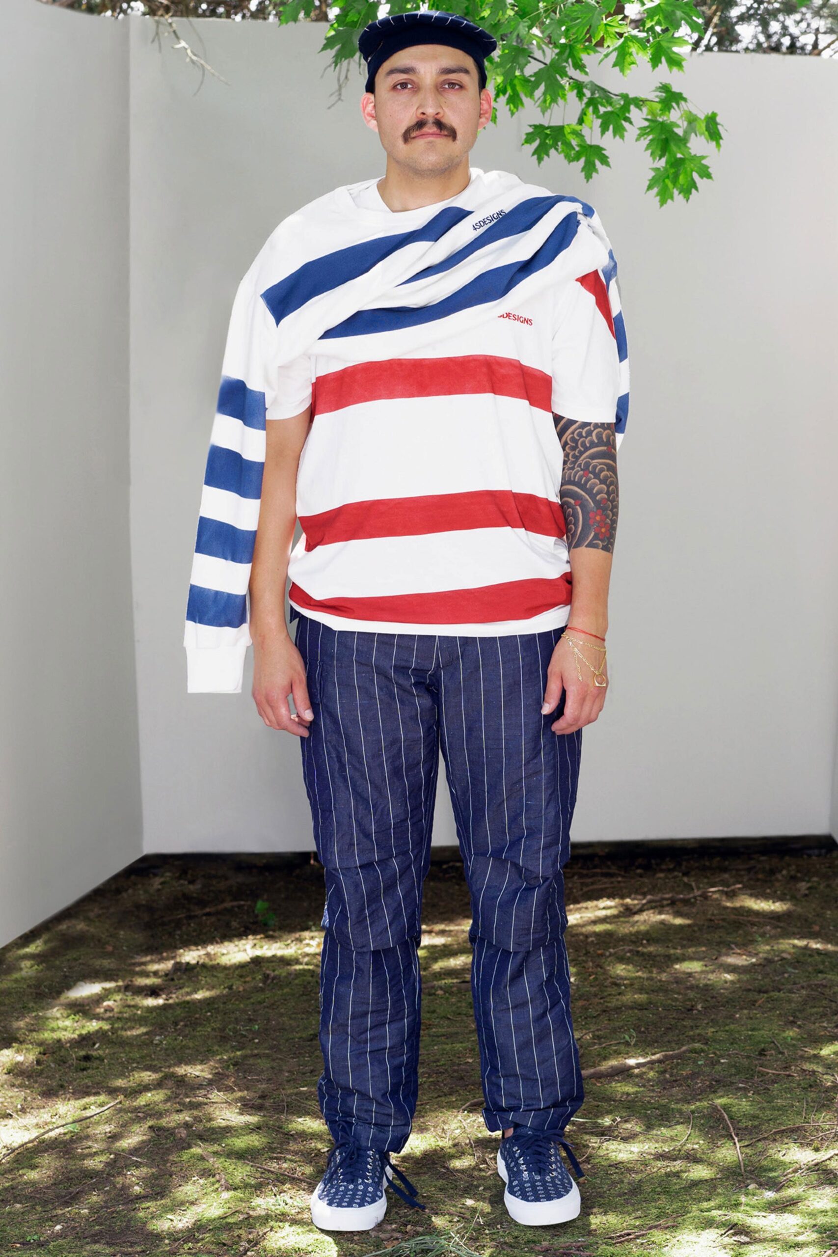 A relaxed fit shirt with red and blue stripes paired with pinstriped pants.