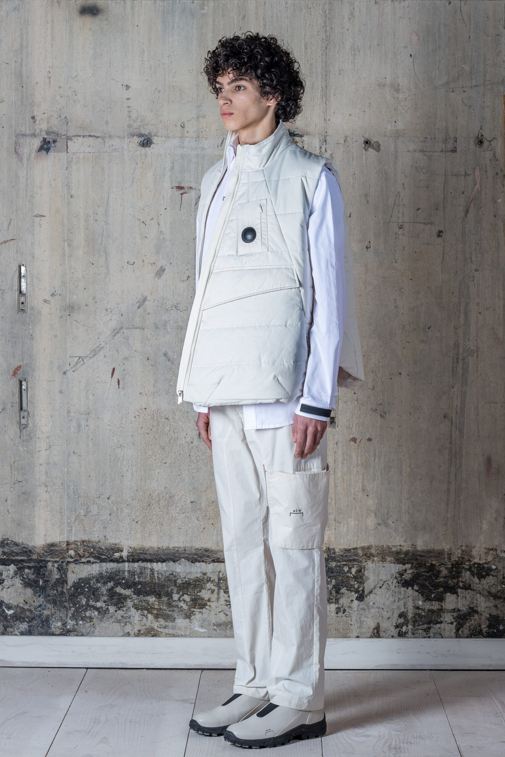 A relaxed white sleeveless vest with a collared design paired with matching pants.