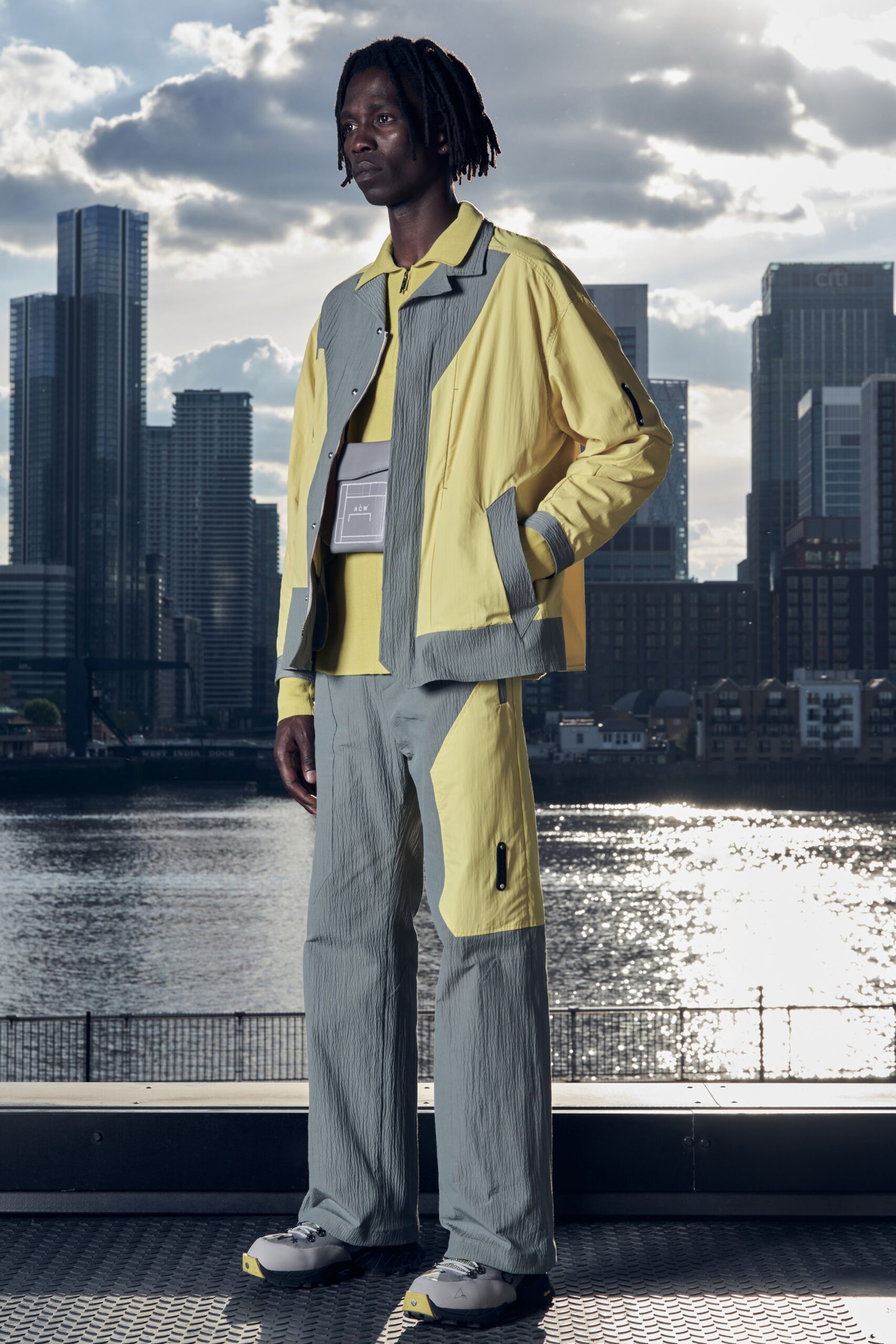 A relaxed yellow and gray jacket paired with matching relaxed-fit pants featuring zippered details.