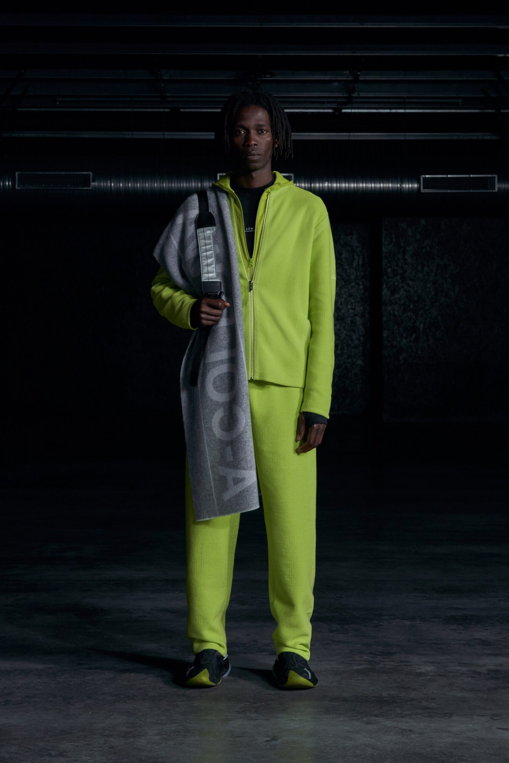 A relaxed neon green jacket with long sleeves and matching pants, featuring a zippered design.