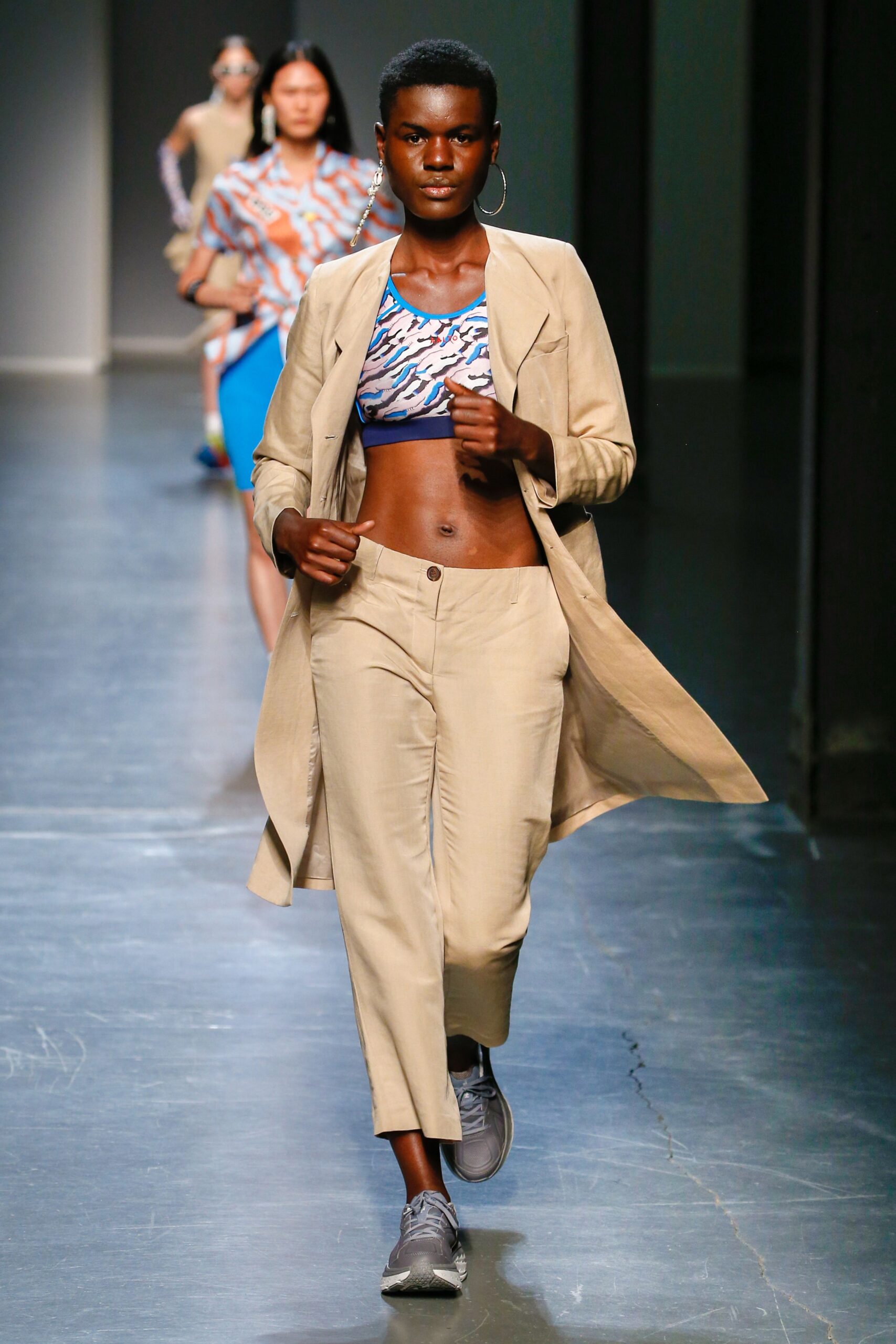 beige trench coat with multi-colored top