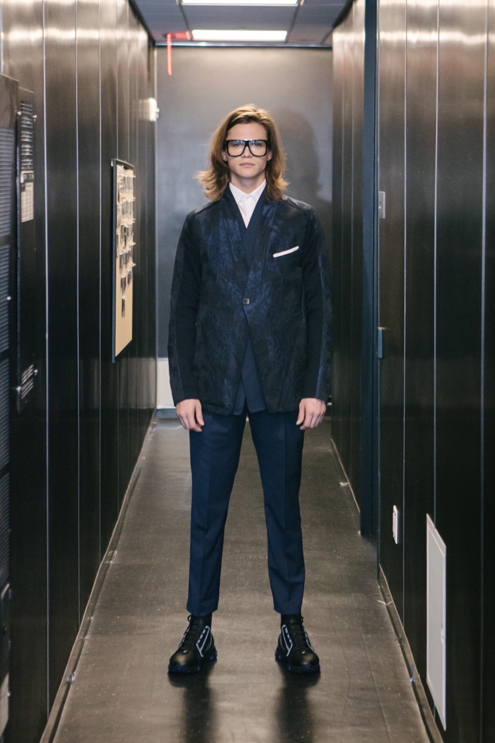 blue tailored suit with black shoes