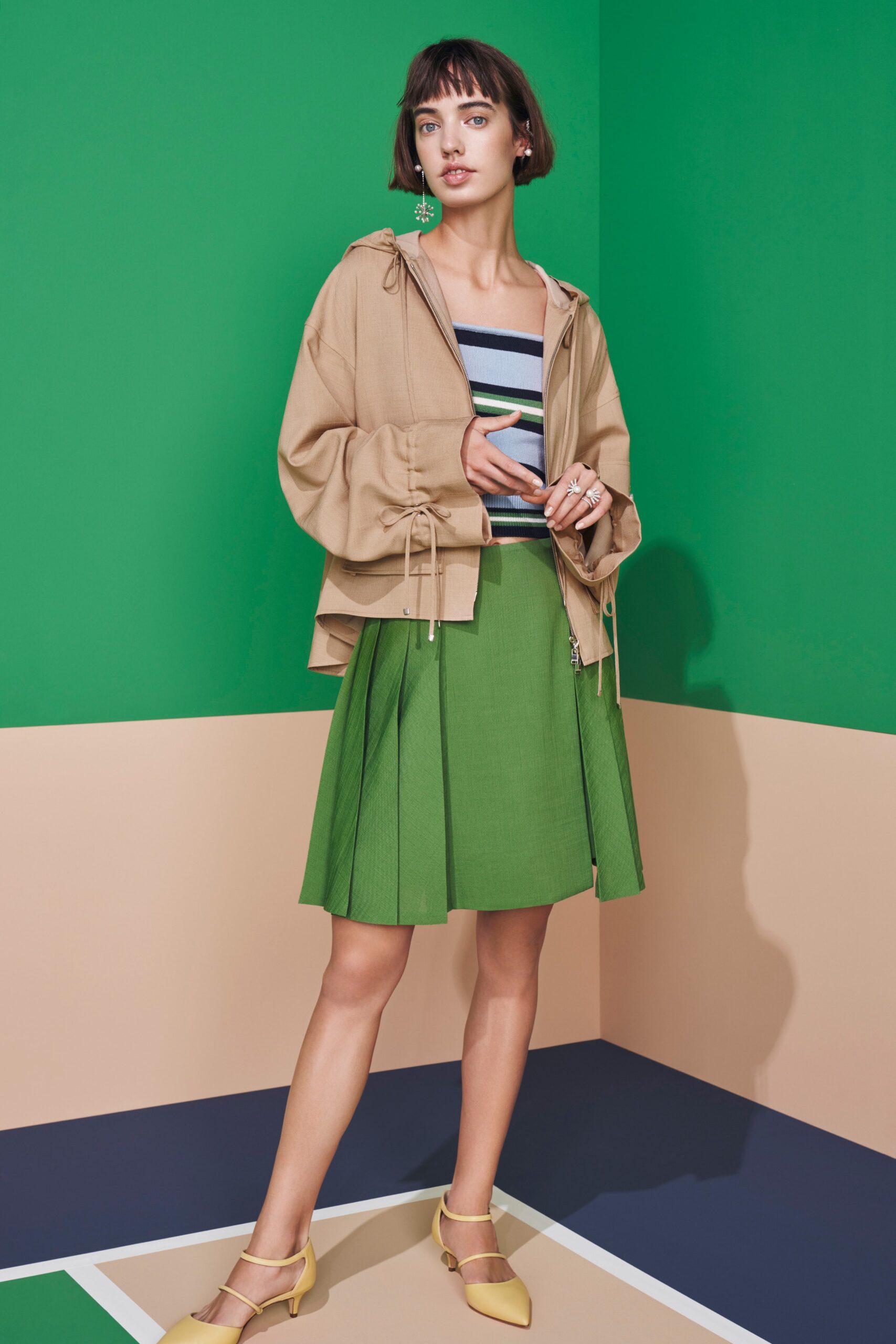 beige oversized hoodie with pleated green skirt