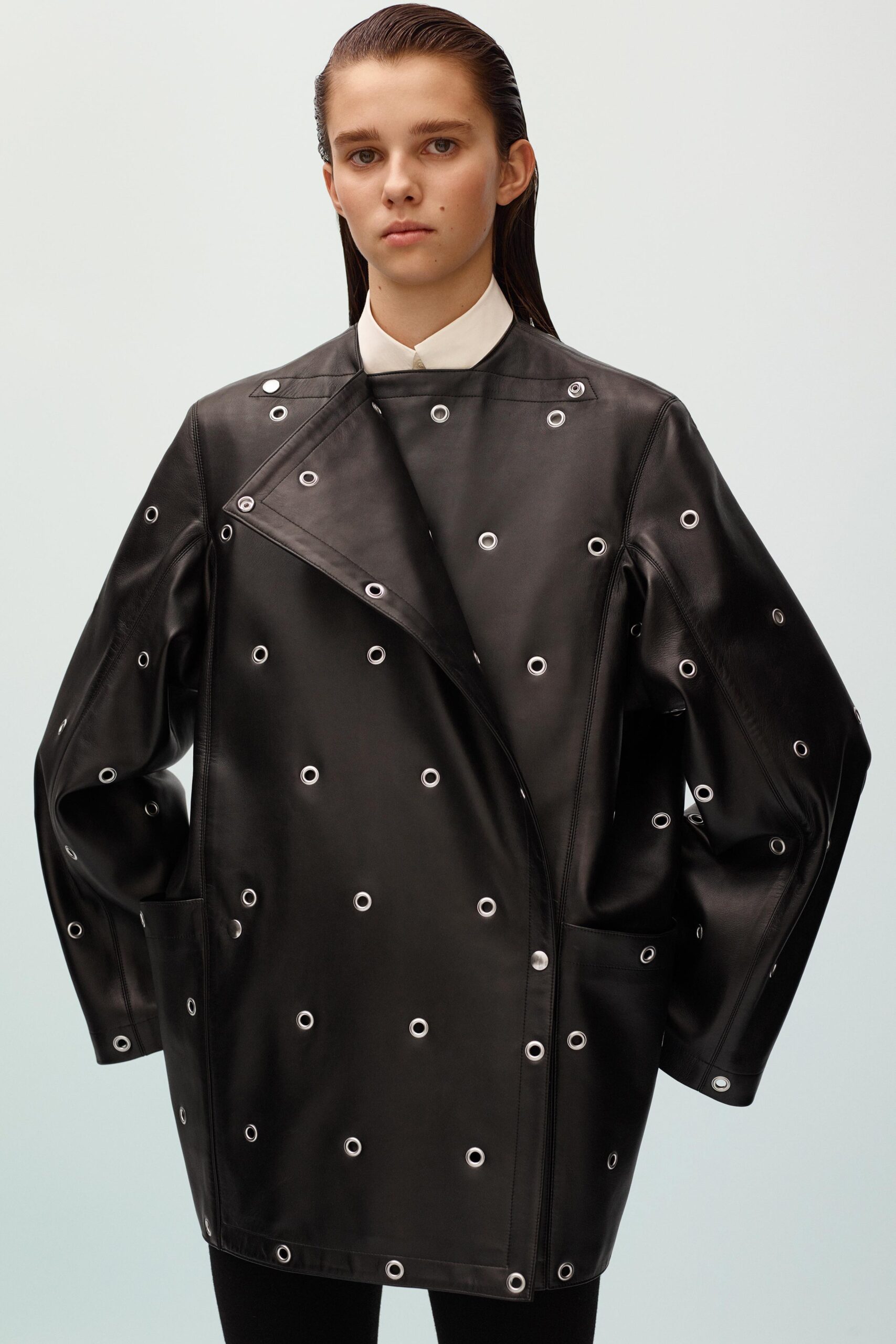 black leather oversized coat and white shirt