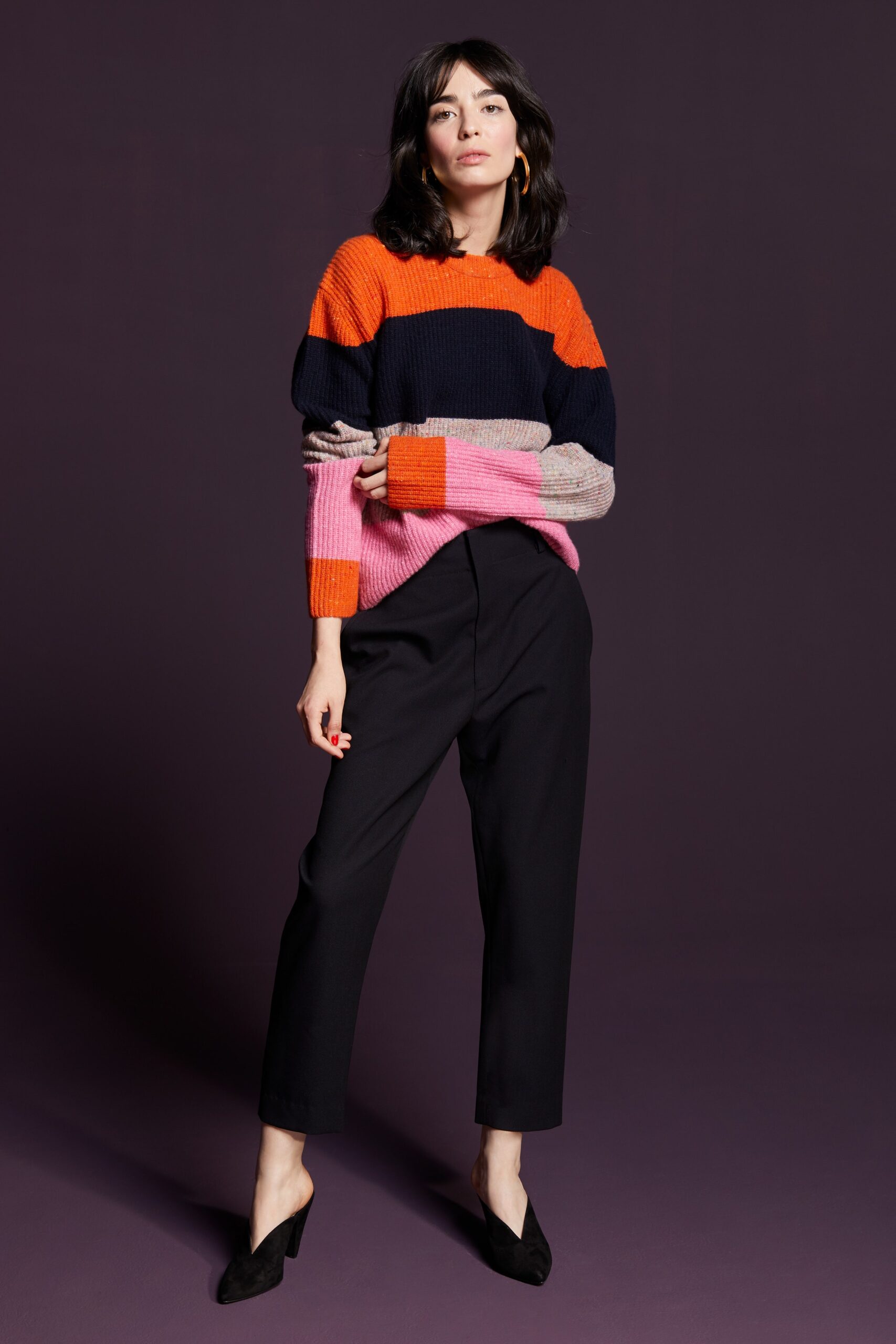 colorful striped sweater with tailored pants