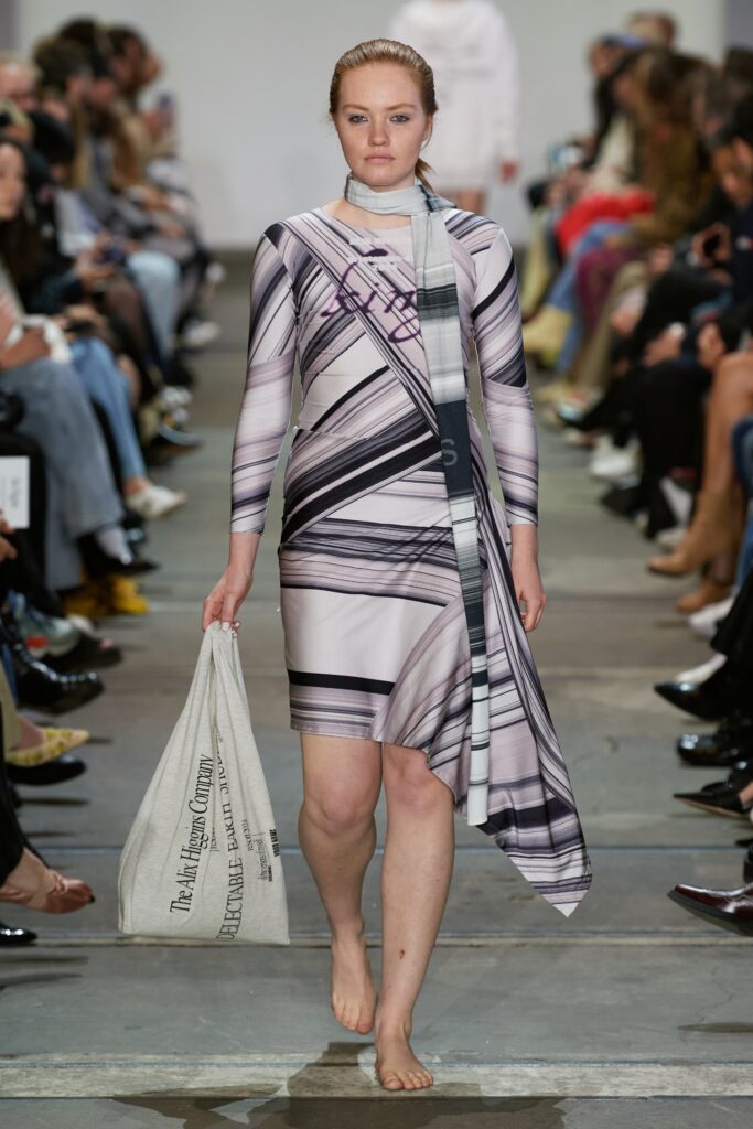 A fitted multicolor dress with long sleeves and an asymmetric design featuring a printed pattern.