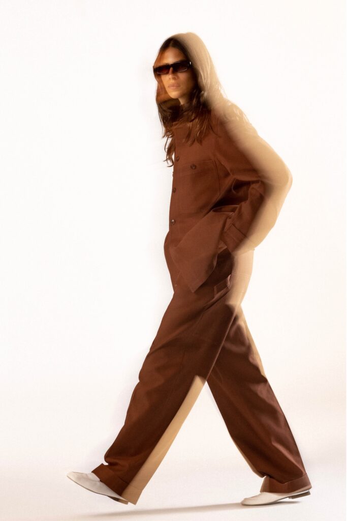 A relaxed brown cotton jacket with long sleeves and wide-leg pants, featuring a collared design.