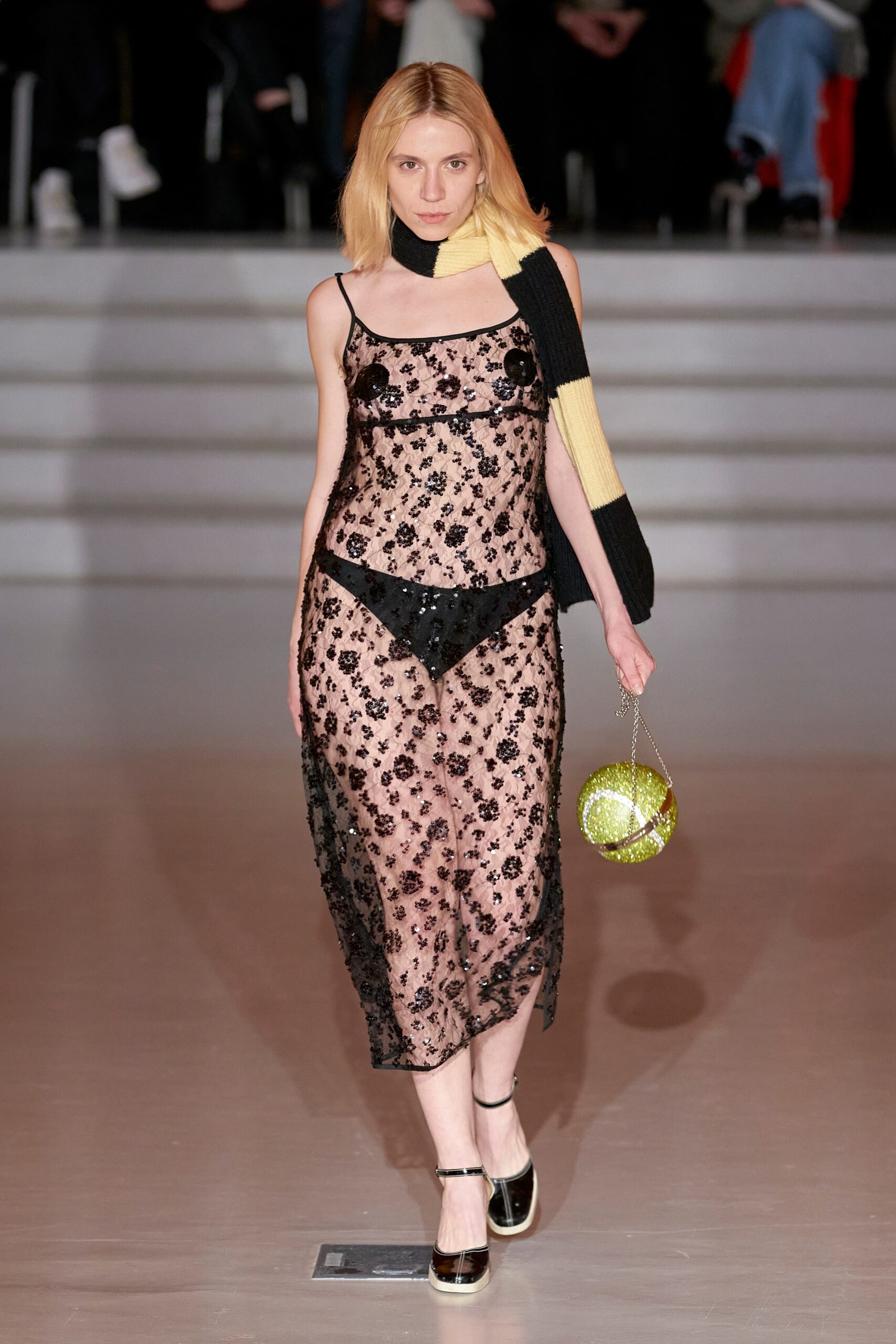 A fitted black lace sleeveless dress with a V-neckline and sheer design.
