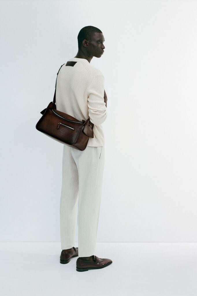 A relaxed white long-sleeve collared shirt paired with beige straight-leg pants.