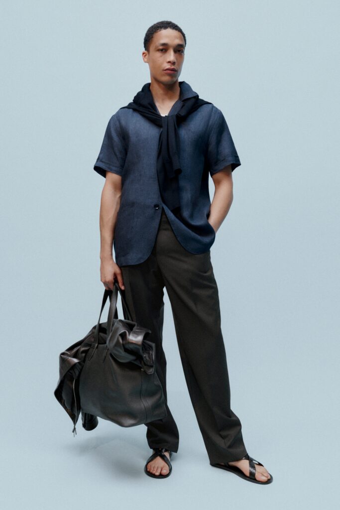 A relaxed blue cotton short-sleeve shirt paired with gray straight-leg pants.