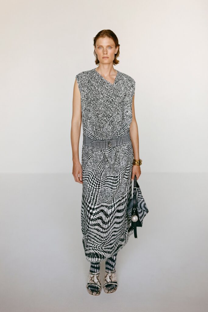 A relaxed black and white printed dress with a sleeveless design and V-neckline.
