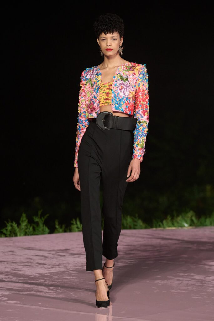 A fitted multicolor embroidered jacket paired with tailored black pants for a chic runway look.