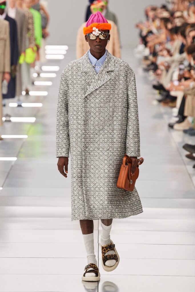 A relaxed gray wool coat with long sleeves and a collared design, featuring button details.