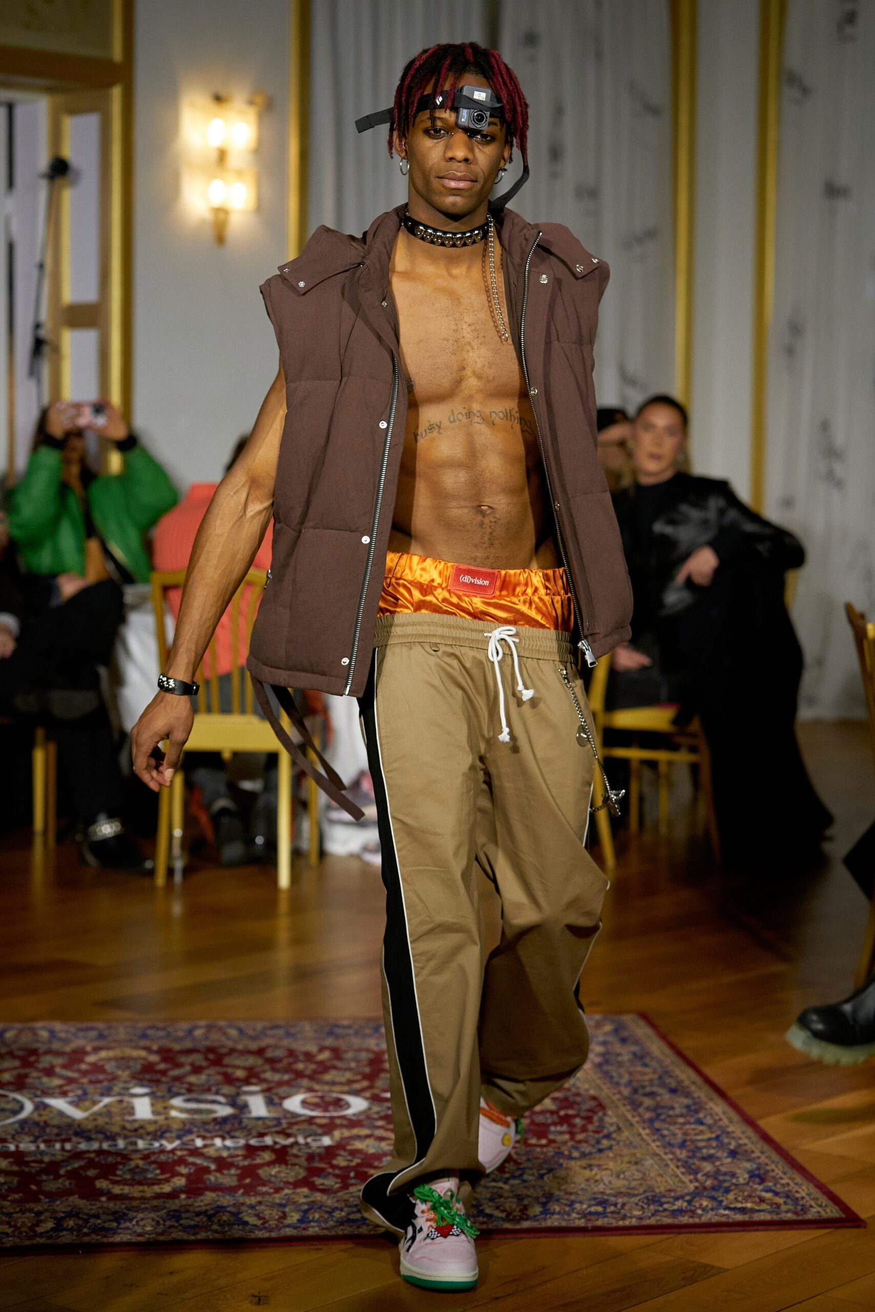A relaxed brown cotton sleeveless vest paired with high-waisted beige pants featuring a wide-leg design.