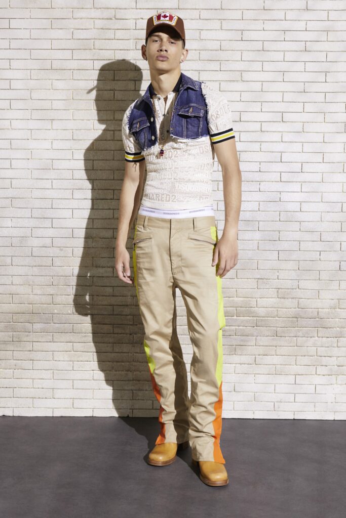 A fitted short-sleeve shirt paired with color-blocked beige pants featuring orange and yellow accents.