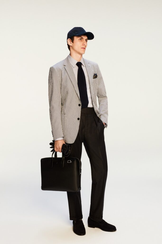 A tailored black and white striped blazer paired with black pants, perfect for a sophisticated look.