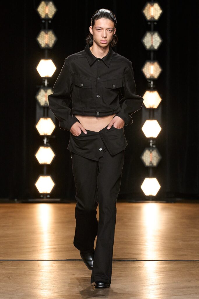 A fitted black cotton jacket with long sleeves and collared design paired with matching pants.