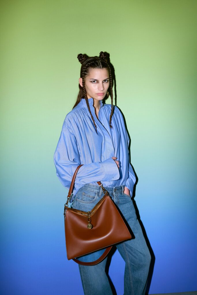 A relaxed blue cotton long-sleeve shirt with a collared design paired with straight-leg pants.