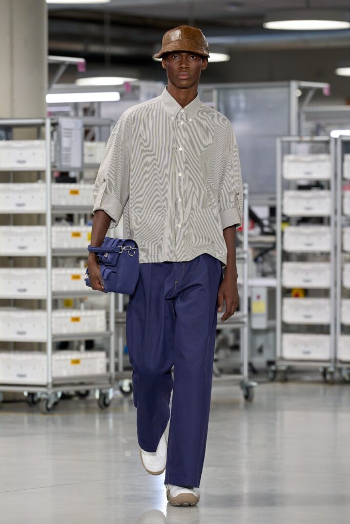 A relaxed fit long-sleeve collared shirt with stripes paired with wide-leg blue pants.