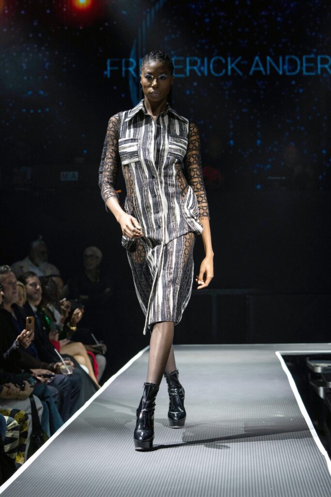 A relaxed black and white striped dress with long sleeves and a collared neckline.