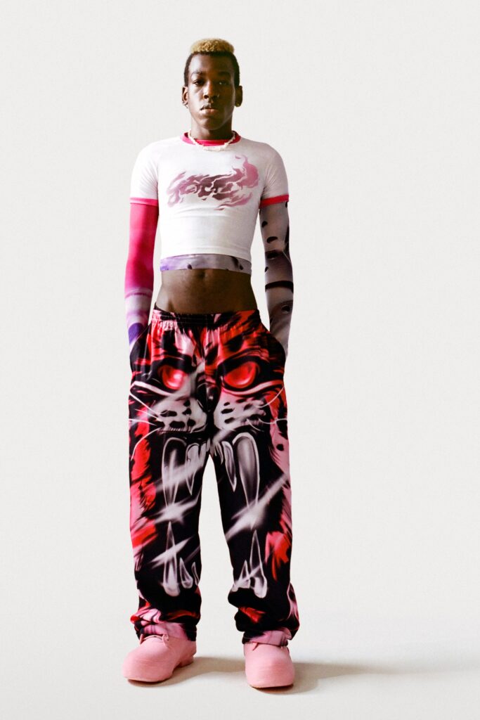 A stylish printed white crop-top paired with high-waisted pants featuring bold graphics and vibrant colors.