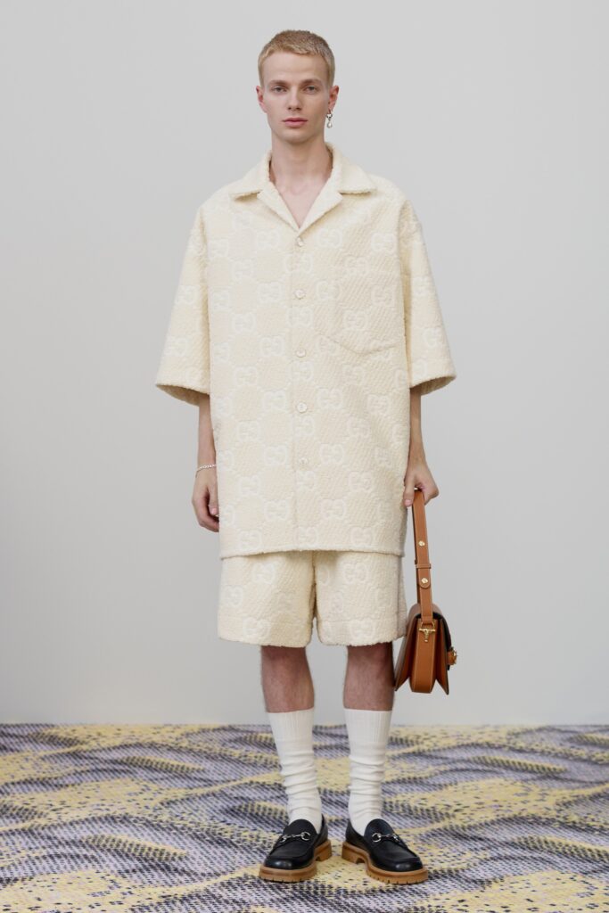 A relaxed beige printed shirt with short sleeves paired with matching shorts.