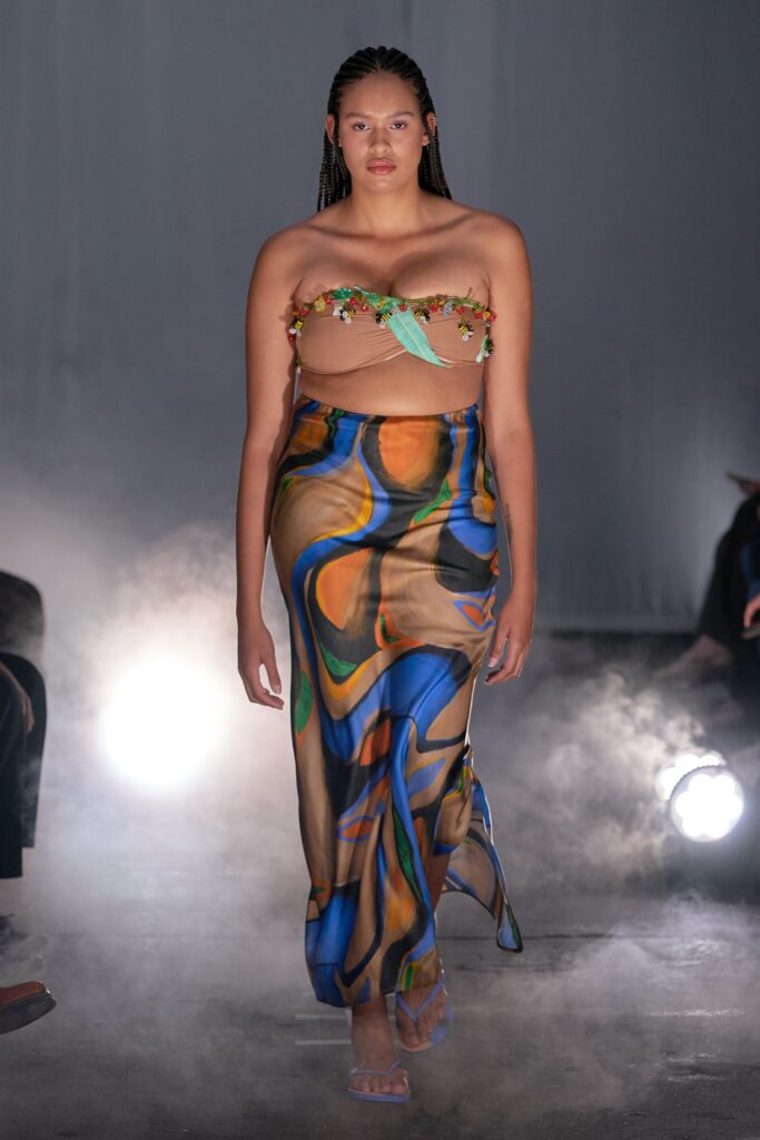 A fitted multicolor silk sleeveless dress with a high-waisted design and asymmetric silhouette.