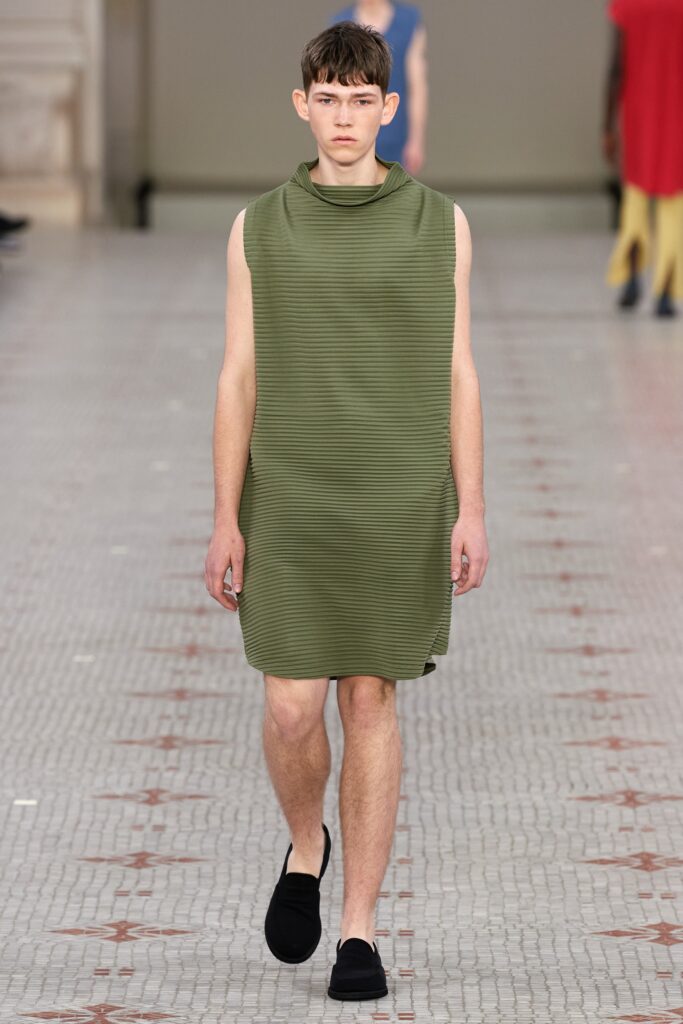 A relaxed green sleeveless dress with a high neckline and straight-leg silhouette.