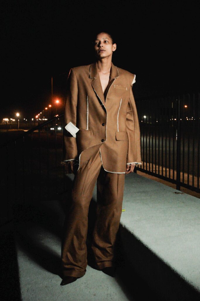A relaxed brown suit with long sleeves, a collared design, and an asymmetric detail.