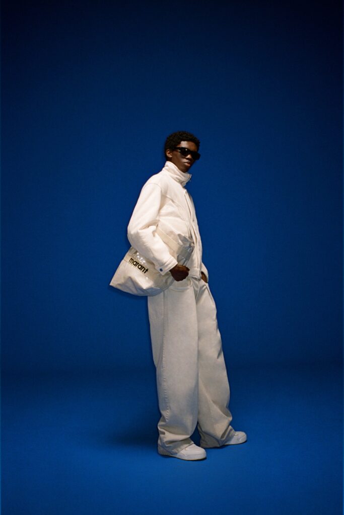 A relaxed white jacket with long sleeves and collared design paired with wide-leg pants.