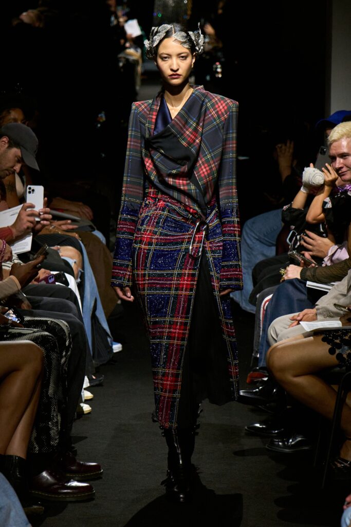 A fitted multicolor plaid dress with long sleeves and an asymmetric design.
