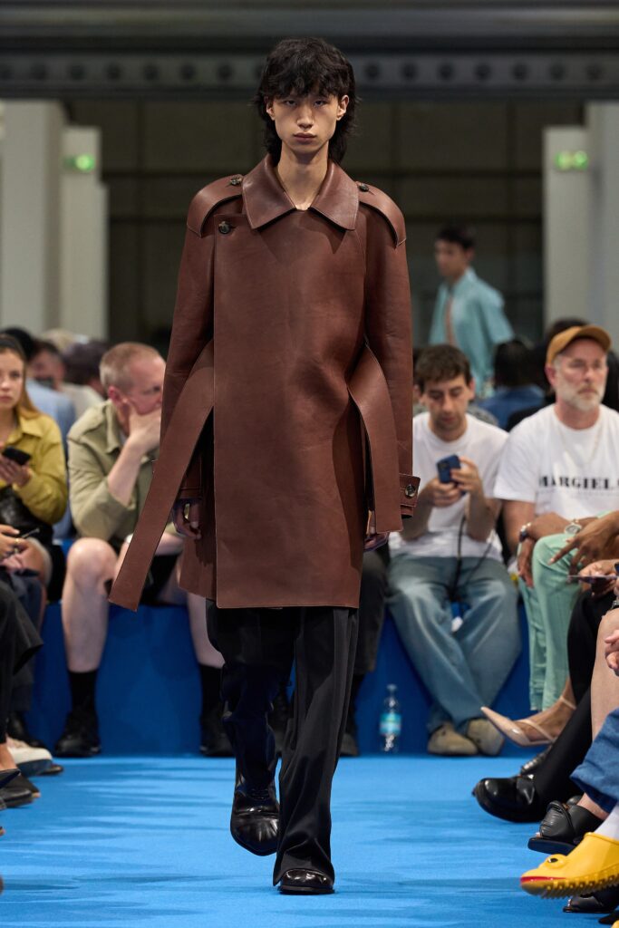 A relaxed brown leather coat with a collared neckline and asymmetric design.