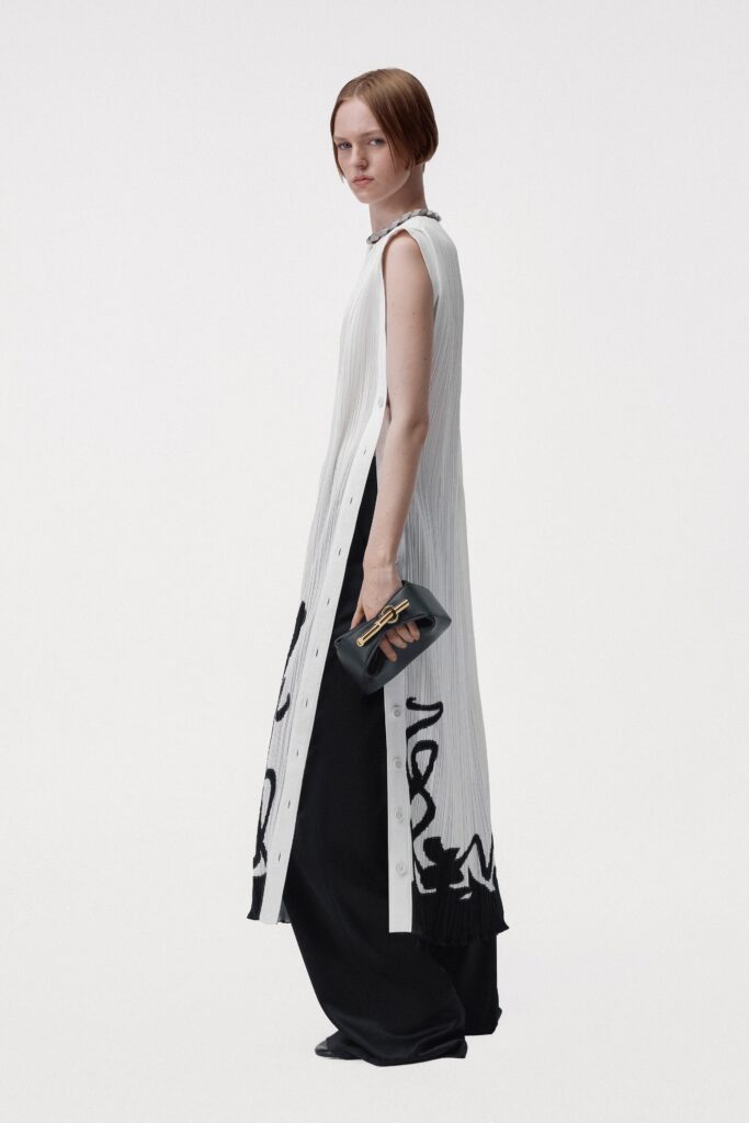 A relaxed black and white sleeveless dress with a collared neckline and asymmetric design.