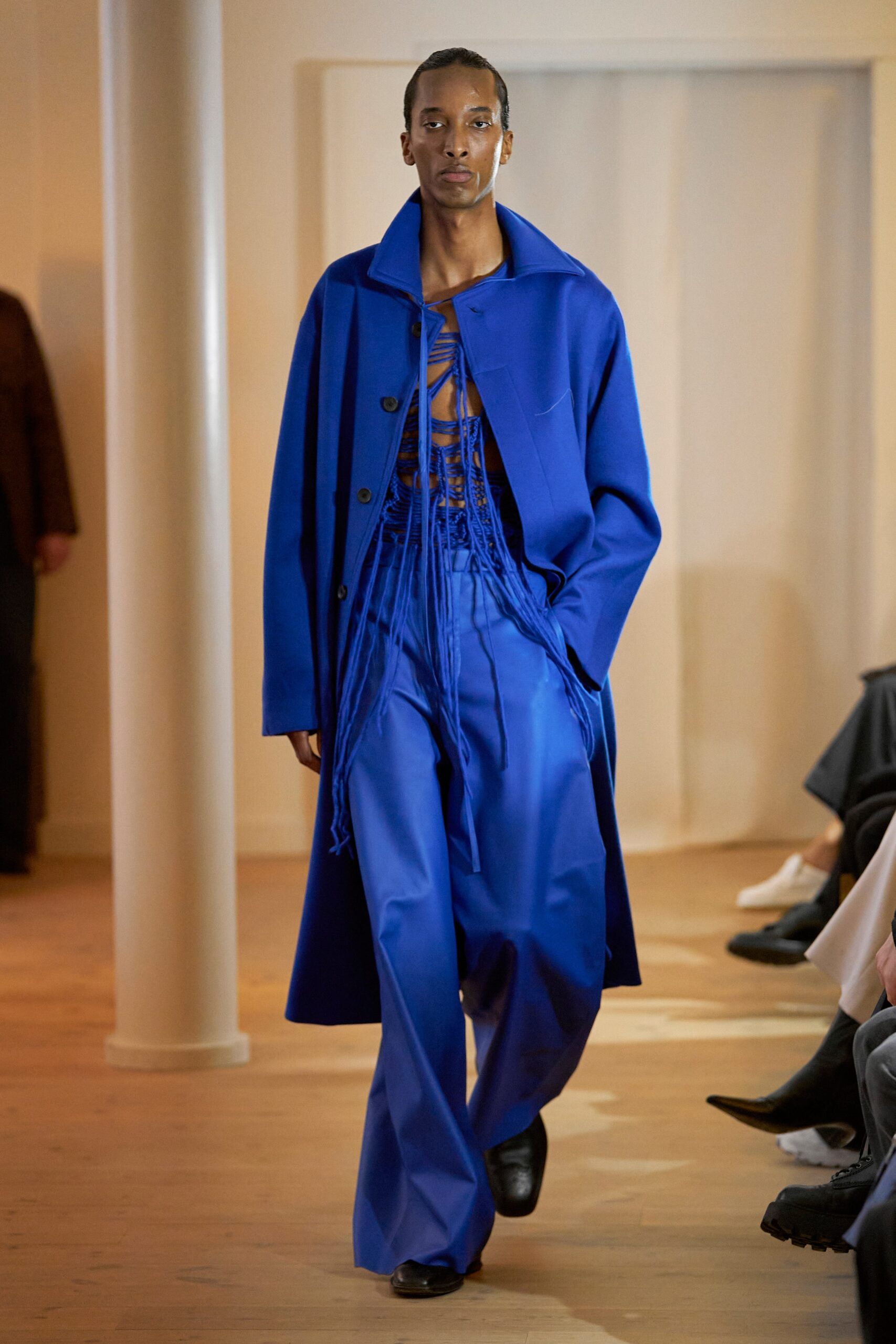 A relaxed blue coat paired with wide-leg pants, featuring a long-sleeve and collared design.