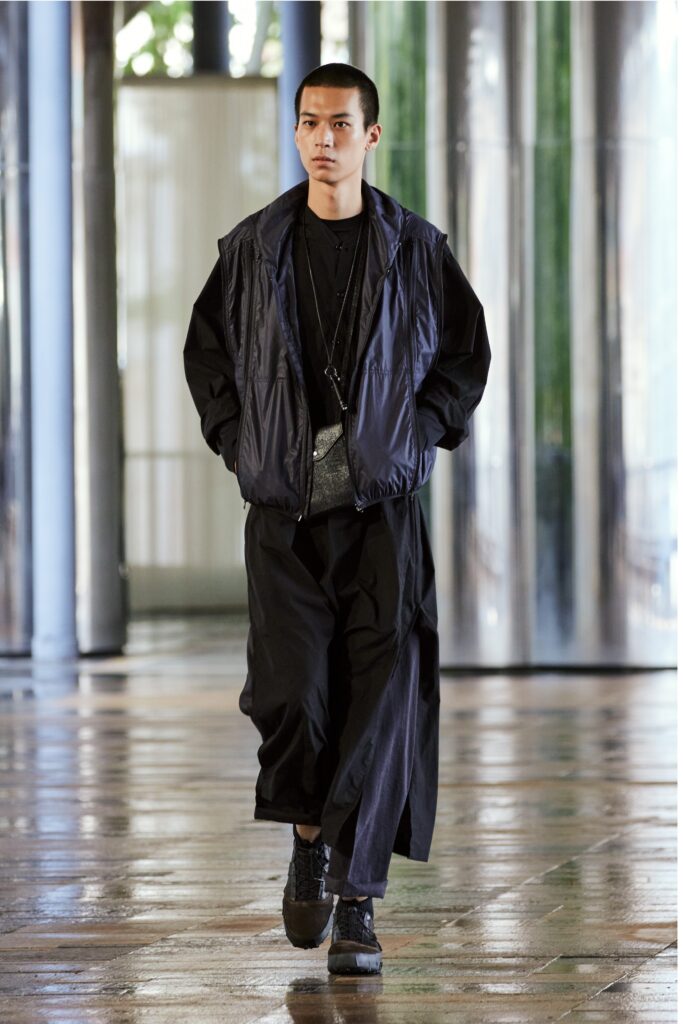 A relaxed black jacket with long sleeves paired with matching pants, featuring a layered design.