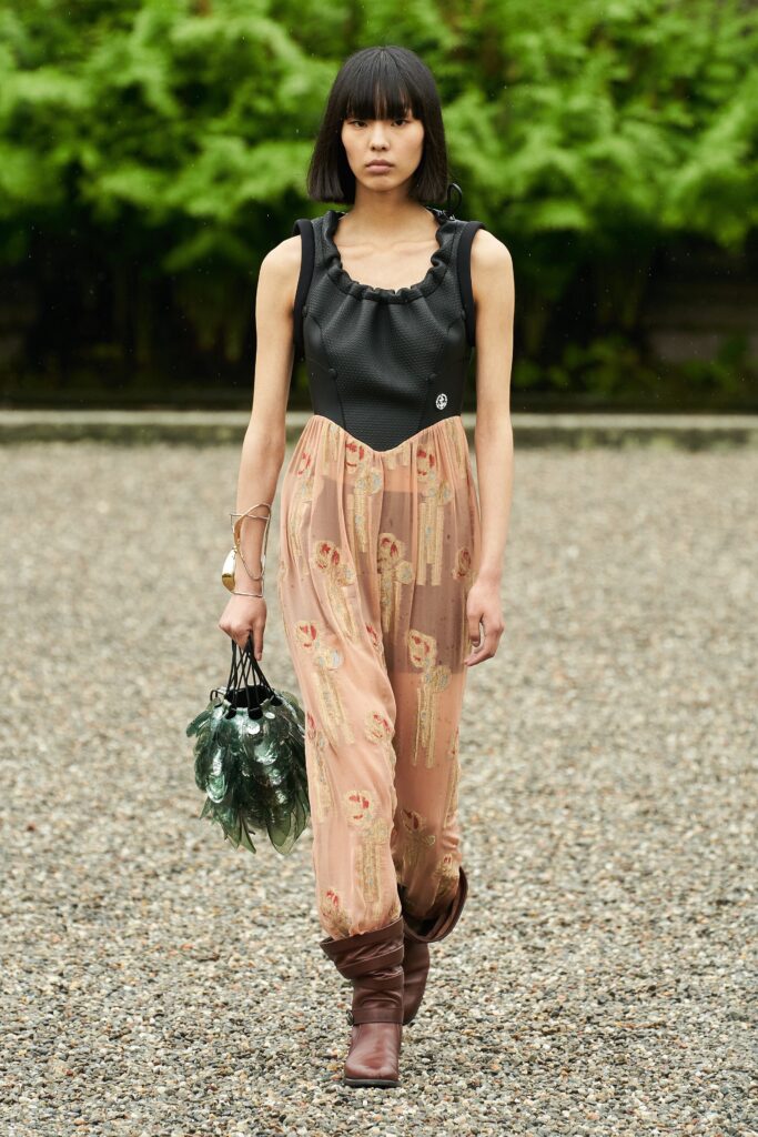 A fitted black and pink sleeveless dress with a V-neckline and flared silhouette.