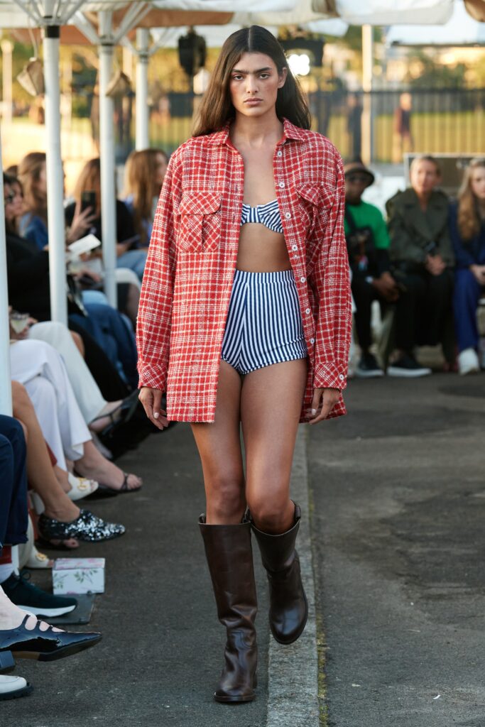 A relaxed red checked long-sleeve shirt paired with a blue striped bikini.
