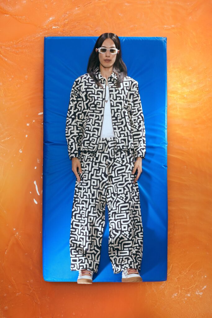 A relaxed fit black and white printed jacket paired with matching pants.