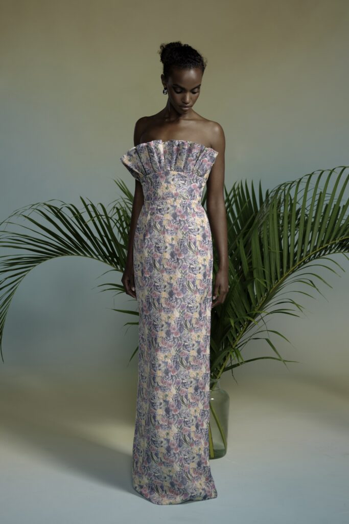 A fitted multicolor silk strapless gown featuring a pleated detail for added elegance.