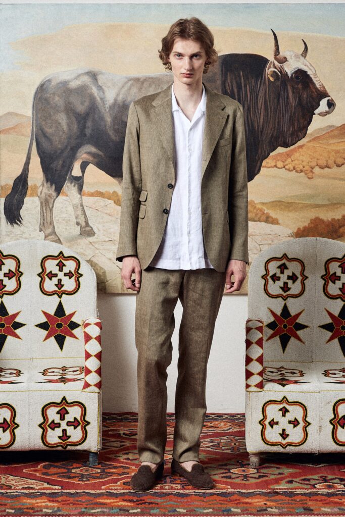 A tailored beige linen suit with a long-sleeve collared shirt and buttoned details.