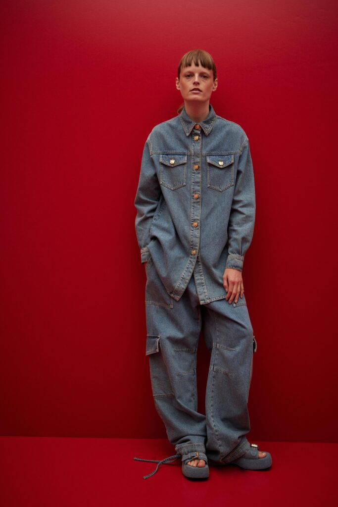 A relaxed fit blue denim shirt with long sleeves and matching pants, featuring a collared neckline.
