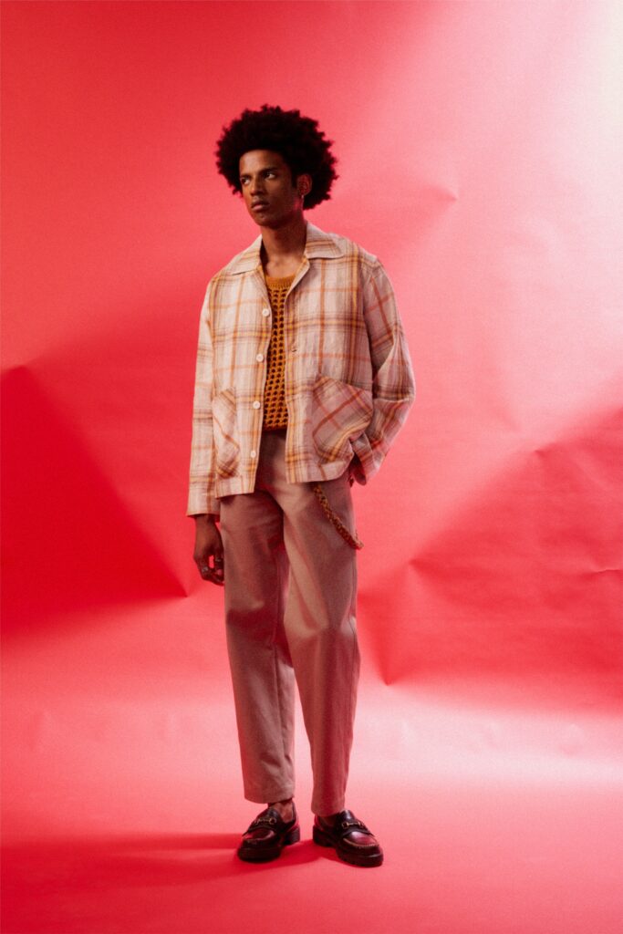 A relaxed beige checked jacket with long sleeves paired with beige pants.