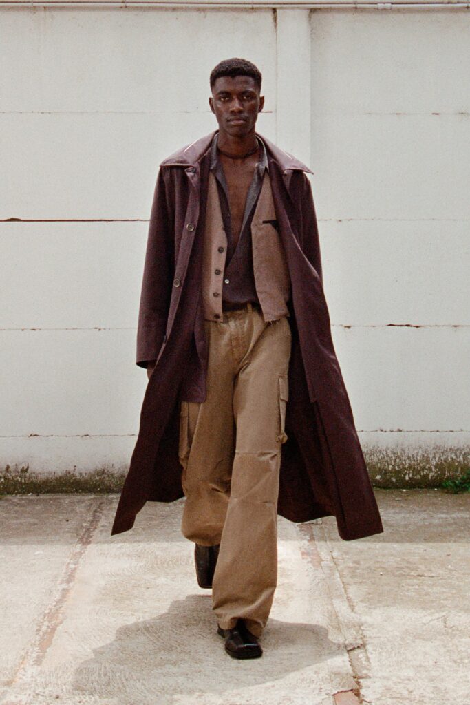A relaxed brown cotton coat paired with a vest, featuring a collared design and buttoned details.