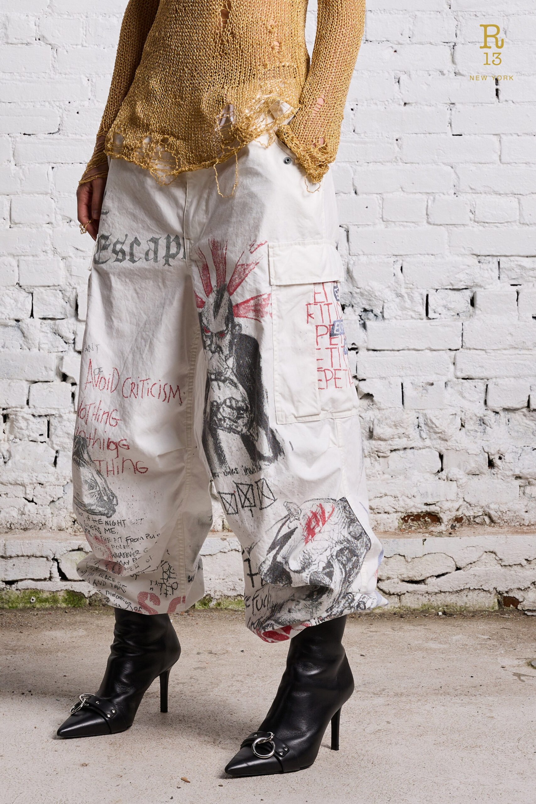 Relaxed white cotton pants featuring various printed designs and a high-waisted construction.